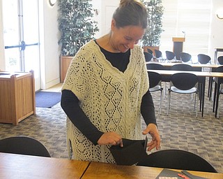 Neighbors | Zack Shively.Librarian Lindsay Platt demonstrated how to fold the paper into a square or upward slant to make a basket at a paper crafting event on Aug. 25 at the Austintown library.