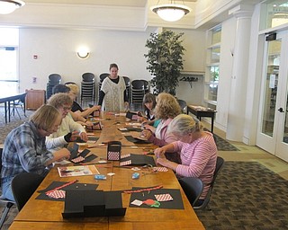 Neighbors | Zack Shively.The class at Austintown library began making their paper baskets shortly after arriving. They used the time to craft and also talk about current events, like concerts and construction.
