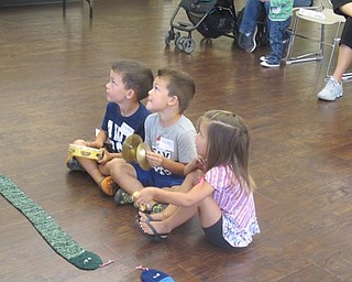 Neighbors | Zack Shively  .Children prepared to play instruments along with "Old MacDonald had a Farm" at the Boardman library on Aug. 30.