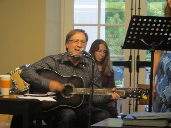 Neighbors | Zack Shively  .Harry Davis of Kristi Blue and the Midnites and the Oakland Center for the Arts played guitar and harmonica and sangs throughout a song on Aug. 31 at the Poland library.