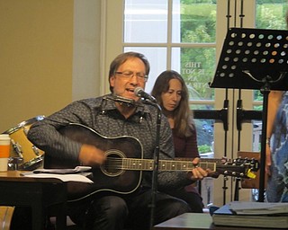 Neighbors | Zack Shively  .Harry Davis of Kristi Blue and the Midnites and the Oakland Center for the Arts played guitar and harmonica and sangs throughout a song on Aug. 31 at the Poland library.
