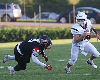 East Palestine quarterback Parker Sherry(10) sheds Campbell defenseman Darrion Jones(9) in the first quarter as East Palestine takes on Campbell, Friday, Sept. 8, 2017, at John Knapick Field at Campbell Memorial High School in Campbell...(Nikos Frazier | The Vindicator)..