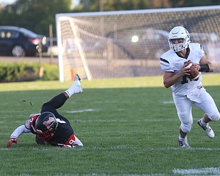 East Palestine quarterback Parker Sherry(10) sheds Campbell defenseman Darrion Jones(9) in the first quarter as East Palestine takes on Campbell, Friday, Sept. 8, 2017, at John Knapick Field at Campbell Memorial High School in Campbell...(Nikos Frazier | The Vindicator)..
