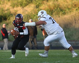 Campbell quarterback Darrion Jones attempts to shed East Palestine defenseman John McLaughlin(72) in the first quarter as East Palestine takes on Campbell, Friday, Sept. 8, 2017, at John Knapick Field at Campbell Memorial High School in Campbell...(Nikos Frazier | The Vindicator)..