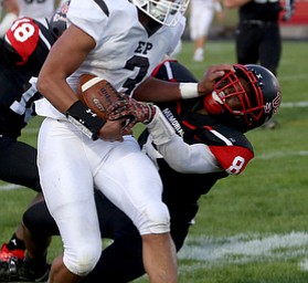 East Palestine running back Dominic Posey(3) is taken down by Campbell defenseman Malachi Bannan(8) in the second quarter as East Palestine takes on Campbell, Friday, Sept. 8, 2017, at John Knapick Field at Campbell Memorial High School in Campbell...(Nikos Frazier | The Vindicator)..