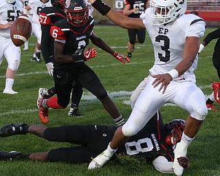 East Palestine running back Dominic Posey(3) looses control of the ball as Campbell defenseman Malachi Bannan(8) tackles him in the second quarter as East Palestine takes on Campbell, Friday, Sept. 8, 2017, at John Knapick Field at Campbell Memorial High School in Campbell...(Nikos Frazier | The Vindicator)..