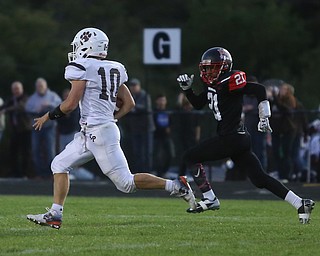 East Palestine quarterback Parker Sherry(10) runs in a touchdown while being pursued by Campbell defenseman Gerald Brown(21) in the second quarter as East Palestine takes on Campbell, Friday, Sept. 8, 2017, at John Knapick Field at Campbell Memorial High School in Campbell...(Nikos Frazier | The Vindicator)..