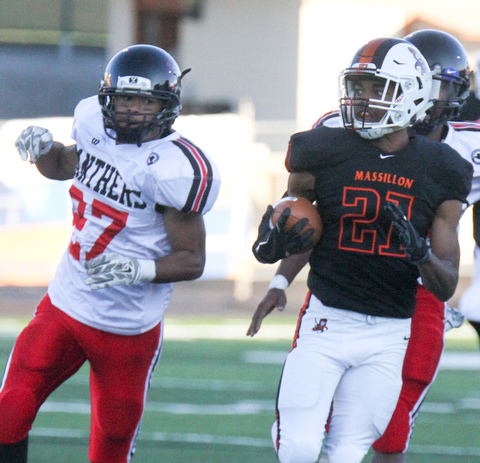William D. Lewis The Vindicator  Massilon's Anthony Ballard(21) eludes Harding's Cameren King(27) while scoring on opening ply of 9-8-17 game at Harding.