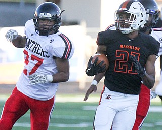 William D. Lewis The Vindicator  Massilon's Anthony Ballard(21) eludes Harding's Cameren King(27) while scoring on opening ply of 9-8-17 game at Harding.