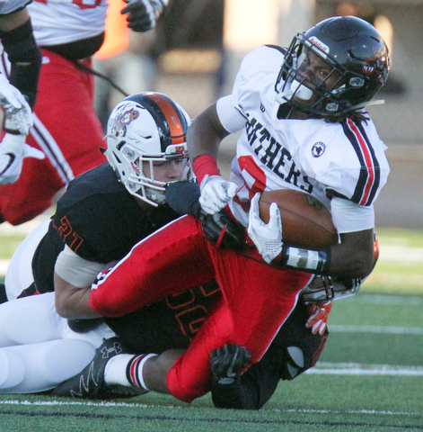 William D. Lewis The Vindicator Harding's KAyron Adams(2) is stopped by MAssilons Preston Hoges(31) and Cameron Sunkle(62) during 9-8-17 game at Harding.