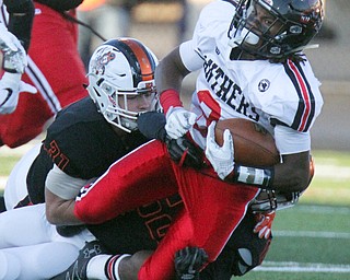 William D. Lewis The Vindicator Harding's KAyron Adams(2) is stopped by MAssilons Preston Hoges(31) and Cameron Sunkle(62) during 9-8-17 game at Harding.