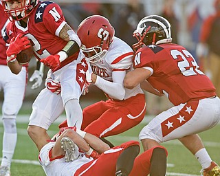 NILES, OHIO - SEPTEMBER 8, 2017: Niles's Jason Johns, left, fights to break free from Struthers's Kevin Caldwell and Nick Adams during the first half of their game Friday night at Niles High School. DAVID DERMER | THE VINDICATOR..Niles's Preston Turner pictured.