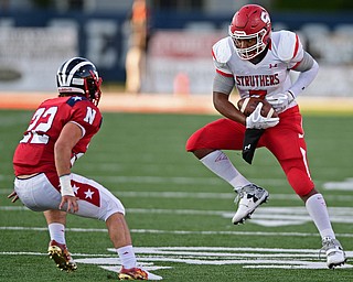 NILES, OHIO - SEPTEMBER 8, 2017: Struthers's Willie Mitchell, right, lands after leaping to catch a pass before being hit by Niles's Preston Turner during the first half of their game Friday night at Niles High School. DAVID DERMER | THE VINDICATOR