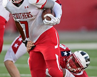 NILES, OHIO - SEPTEMBER 8, 2017: Struthers's Willie Mitchell runs the ball while Niles's Nick Dobbins hangs on to attempt to being him down during the first half of their game Friday night at Niles High School. DAVID DERMER | THE VINDICATOR