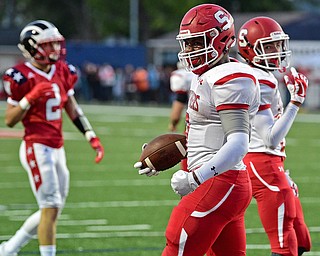 NILES, OHIO - SEPTEMBER 8, 2017: Struthers's Willie Mitchell, left, flexes after running over several Niles players and scoring a touchdown during the first half of their game Friday night at Niles High School. DAVID DERMER | THE VINDICATOR..Niles's Jason Johns and Struthers's Kevin Caldwell pictured.