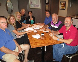 As American flags reappear in Austintown for the second half of the season, Rotary Club members are preparing payment notices for current customers of the flag program. The cost is $30 per year, and the program gives families a flag in their yard for six holidays each year. These flags flew for Labor Day and will be displayed on Patriots Day (9/11) and Veterans Day. Interested residents can check the Rotary website at austintownflags.com for an application form. Above, Rotarians working, from left, are Ron Carroll, Chris Vlosich, Tracie Kaglic, Bruce Laraway, Heather Fronk, Mal Culp and John Mashiska.