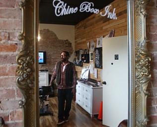 Reflection of Aaron Chine in his studio space, Thursday, August 24, 2017 at The Box Gallery in Warren...(Nikos Frazier | The Vindicator)