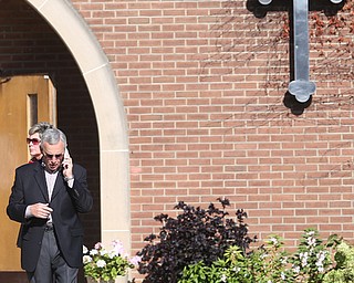YSU President Jim Tressel talks on his phone during former state Sen. Harry Meshel's funeral, Sept. 9, 2017, at St. Nicholas Greek Orthodox Church in Youngstown...(Nikos Frazier | The Vindicator)