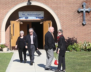 YSU President Jim Tressel(second left) and wife, Ellen Tressel(right) during former state Sen. Harry Meshel's funeral, Sept. 9, 2017, at St. Nicholas Greek Orthodox Church in Youngstown...(Nikos Frazier | The Vindicator)