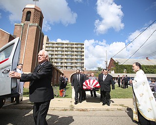 A veteran salutes as the casket bearing former state Sen. Harry Meshel's exits the church, Sept. 9, 2017, at St. Nicholas Greek Orthodox Church in Youngstown...(Nikos Frazier | The Vindicator)