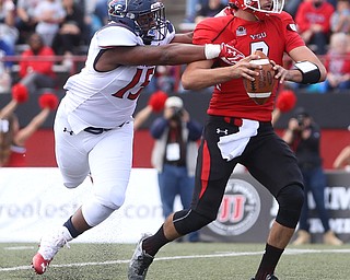 Youngstown State University quarterback Nathan Mays (7) attempts to shed Robert Morris University defensive lineman Derian Smith (15) in the first quarter as Robert Morris University takes on Youngstown State University, Saturday, Sept. 9, 2017, at Stambaugh Stadium in Youngstown. Youngstown State won 30-0...(Nikos Frazier | The Vindicator)..