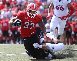 Youngstown State University tail back Tevin McCaster (37) is tackled by Robert Morris University linebacker Joseph Uhatafe (10) in the first quarter as Robert Morris University takes on Youngstown State University, Saturday, Sept. 9, 2017, at Stambaugh Stadium in Youngstown. Youngstown State won 30-0...(Nikos Frazier | The Vindicator)..