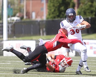 Robert Morris University running back Cole Blake (36) is tackled by Youngstown State University safety Kyle Hegedus (10) in the first quarter as Robert Morris University takes on Youngstown State University, Saturday, Sept. 9, 2017, at Stambaugh Stadium in Youngstown. Youngstown State University line backer Armand Dellovade (42) looks on in the background. Youngstown State won 30-0. ..(Nikos Frazier | The Vindicator)..