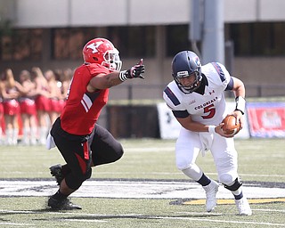 Robert Morris University quarterback Jimmy Walker (5) braces to dodge Youngstown State University defensive end Justus Reed (4) in the second quarter as Robert Morris University takes on Youngstown State University, Saturday, Sept. 9, 2017, at Stambaugh Stadium in Youngstown. Youngstown State won 30-0...(Nikos Frazier | The Vindicator)..