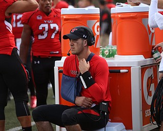 Youngstown State University quarterback Hunter Wells (6) sits on a cooler with his arm in a sling in the second quarter as Robert Morris University takes on Youngstown State University, Saturday, Sept. 9, 2017, at Stambaugh Stadium in Youngstown. Youngstown State won 30-0...(Nikos Frazier | The Vindicator)..