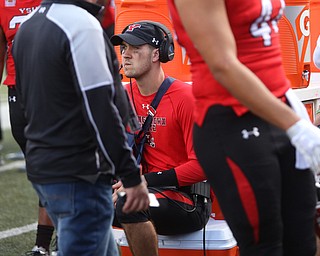 Youngstown State University quarterback Hunter Wells (6) sits on a cooler with his arm in a sling in the second quarter as Robert Morris University takes on Youngstown State University, Saturday, Sept. 9, 2017, at Stambaugh Stadium in Youngstown. Youngstown State won 30-0...(Nikos Frazier | The Vindicator)..