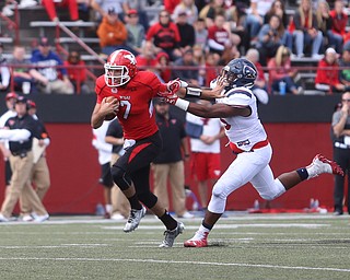 Youngstown State University quarterback Nathan Mays (7) pushes off Robert Morris University defensive lineman Derian Smith (15) in the third quarter as Robert Morris University takes on Youngstown State University, Saturday, Sept. 9, 2017, at Stambaugh Stadium in Youngstown. Youngstown State won 30-0...(Nikos Frazier | The Vindicator)..