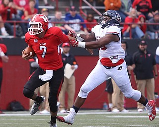 Youngstown State University quarterback Nathan Mays (7) pushes off Robert Morris University defensive lineman Derian Smith (15) in the third quarter as Robert Morris University takes on Youngstown State University, Saturday, Sept. 9, 2017, at Stambaugh Stadium in Youngstown. Youngstown State won 30-0...(Nikos Frazier | The Vindicator)..
