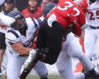 Robert Morris University linebacker Adam Wollet (33)(left) takes down Youngstown State University tail back Tevin McCaster (37) in the first quarter as Robert Morris University takes on Youngstown State University, Saturday, Sept. 9, 2017, at Stambaugh Stadium in Youngstown. Youngstown State won 30-0...(Nikos Frazier | The Vindicator)..