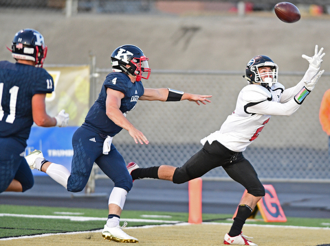 WARREN, OHIO - SEPTEMBER 9, 2017: Girard's Michael Belcik catches a touchdown after getting behind JFK's Gregory Valent, center, and Alec Burzynski during the first half of their game Saturday night at Warren Harding High School. DAVID DERMER | THE VINDICATOR
