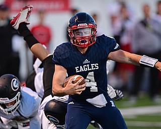 WARREN, OHIO - SEPTEMBER 9, 2017: JFK's Gregory Valent runs the ball while running through arm tackles by Girard's Nick Malito, left, and Cameron LaMonica and into the end zone to score a touchdown during the first half of their game Saturday night at Warren Harding High School. DAVID DERMER | THE VINDICATOR