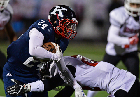 WARREN, OHIO - SEPTEMBER 9, 2017: JFK's Jordan Edmondson, left, runs the ball while being hit by Girard's Nino Mayle during the second half of their game Saturday night at Warren Harding High School. DAVID DERMER | THE VINDICATOR
