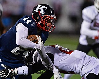 WARREN, OHIO - SEPTEMBER 9, 2017: JFK's Jordan Edmondson, left, runs the ball while being hit by Girard's Nino Mayle during the second half of their game Saturday night at Warren Harding High School. DAVID DERMER | THE VINDICATOR
