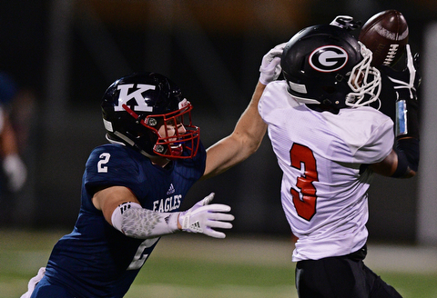 WARREN, OHIO - SEPTEMBER 9, 2017: Girard's Devin Wilson catches a pass while being covered by JFK's Thomas Yanovich during the second half of their game Saturday night at Warren Harding High School. DAVID DERMER | THE VINDICATOR