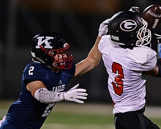 WARREN, OHIO - SEPTEMBER 9, 2017: Girard's Devin Wilson catches a pass while being covered by JFK's Thomas Yanovich during the second half of their game Saturday night at Warren Harding High School. DAVID DERMER | THE VINDICATOR