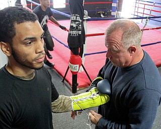 William D Lewis The Vindicator  Popo Salinas gets help with gloves from Jack Loew.