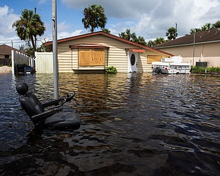 Floodwater caused by Hurricane Irma in Bonita Springs, Fla., surrounds a home on Monday, Sept. 11, 2017. (Nicole Raucheisen/Naples Daily News via AP)