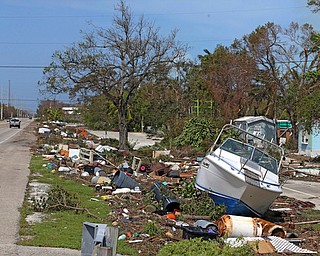 Debris from Hurricane Irma lays on the side of the Overseas Highway in Islamorda in the Florida Keys on Monday, Sept. 11, 2017, as Hurricane Irma passes. (Charles Trainor Jr/Miami Herald via AP)