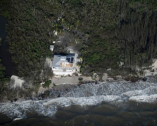 Damage to a roof is shown in the aftermath of Hurricane Irma, Monday, Sept. 11, 2017, in South West coast of Florida. (Matt McClain/The Washington Post via AP, Pool)