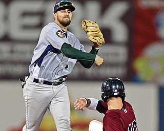 NILES, OHIO - SEPTEMBER 11, 2017: Vermont's Javier Godard, left, throws to first after getting out Mahoning Valley's Nolan Jones in the fourth inning of Monday nights New York - Penn League playoff game at Eastwood Field. Ulysses Cantu was out at first for the double play. DAVID DERMER | THE VINDICATOR