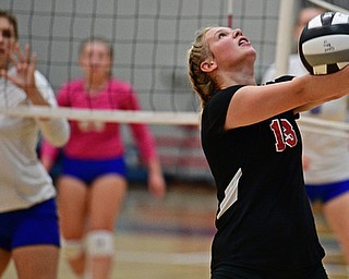 HUBBARD, OHIO - SEPTEMBER 12, 2017: Canfield's Morgan Cleevely, right, hits the ball while Hubbard's Gracie Bencetic watches during their match, Tuesday night at Hubbard High School. DAVID DERMER | THE VINDICATOR
