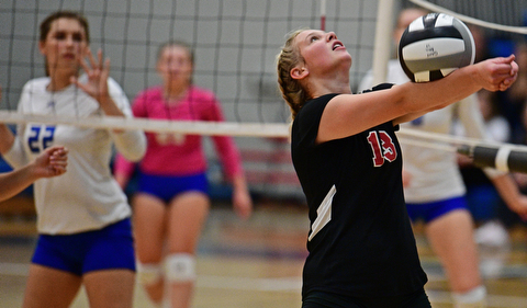 HUBBARD, OHIO - SEPTEMBER 12, 2017: Canfield's Morgan Cleevely, right, hits the ball while Hubbard's Gracie Bencetic watches during their match, Tuesday night at Hubbard High School. DAVID DERMER | THE VINDICATOR