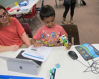 Neighbors | Zack Shively .A child learns about robitics and programming at Lego WeDo Robots on Aug. 7 at the main library.