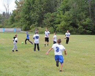 Neighbors | Submitted.Poland Dobbins Elementary students played football and soccer in the side yard of the building before Poland took on Niles McKinley High School.