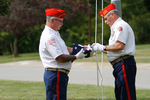     ROBERT K. YOSAY  | THE VINDICATOR..Post 472 and Neil Kennedy Recovery Centers joined forces to paint the flag pole and raise a new flag - with the date 9/11 - as a background Jeff Gulling and Gene Apgar with  Tri-State Marine Corps League #494  officially raised the new flag ...-30-