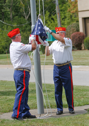     ROBERT K. YOSAY  | THE VINDICATOR..Post 472 and Neil Kennedy Recovery Centers joined forces to paint the flag pole and raise a new flag - with the date 9/11 - as a background Jeff Gulling and Gene Apgar with  Tri-State Marine Corps League #494  officially raised the new flag ...-30-
